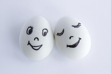 Funny eggs imitating a happy couple of smiling lovers