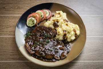 beef steak meal with mashed potato and gravy sauce