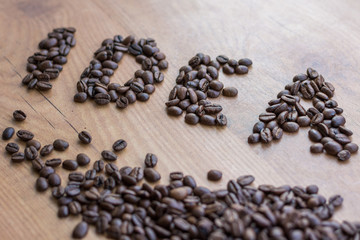 Conceptional sign IDEA drawn among brown roasted coffee beans