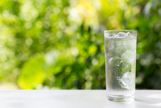 A Glass Of Cold Water With Nature Background.