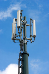 Telecommunications Tower with Blue Sky and Clouds