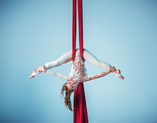 Graceful gymnast performing aerial exercise