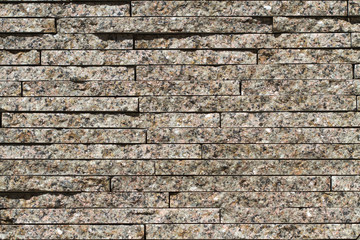 Varicoloured granite blocks of wall for background and texture