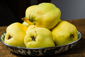 Yellow quince on wooden table