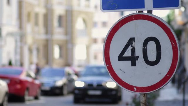Speed limit sign in the city street on summer day