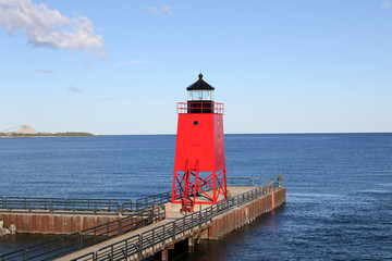 The red lighthouse at the entrance to the harbor at Charlevoix, Michigan from Lake Michigan.