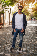 Handsome young man posing on the street