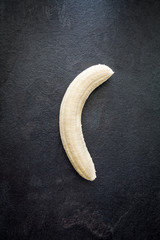 Peeled banana on slate