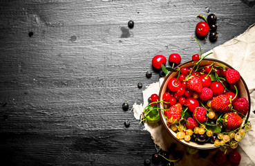 Berries in a Cup on the old fabric.