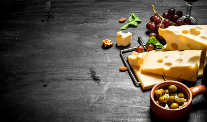 Aromatic cheese with olives and red grapes.