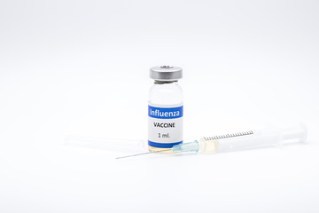Influenza H1N1 vaccine and syringe on white background