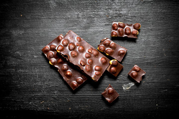 The chunks of chocolate with whole hazelnuts .