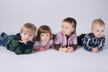 happy children lying on white floor