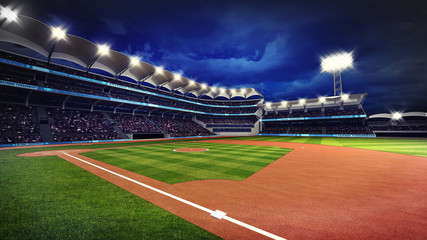 illuminated baseball stadium with spectators and green grass