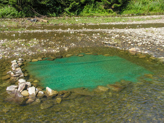 На дно запруды в горной речке постелили ковролин для удобства купающихся
