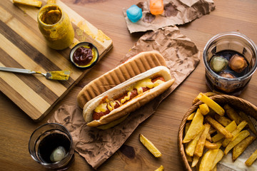 Hot Dog Sandwich with Yellow Mustard, Beverage and Potatoes.