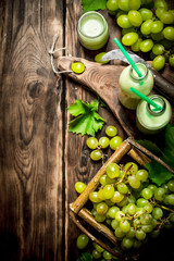 Grape smoothie and a basket of white grapes.