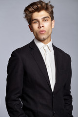 Half-length portrait of young handsome man in suit
