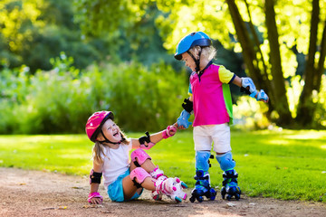 Kids roller skating in summer park
