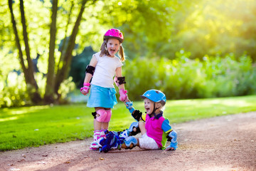 Kids roller skating in summer park