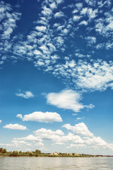 Waterfront on the Danube river and blue sky with clouds