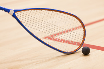 squash racket and ball over wooden background - 119550813