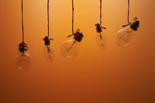 bulbs hanging on laces on an orange background