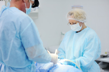 surgeons operate on a patient in the background Surgical Lamp