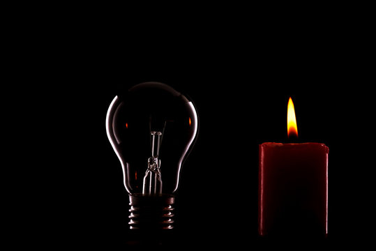 Tungsten and candle on a black background
