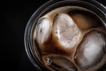 Top view of a cola soda glass with ice