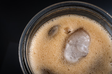 Top view of a cola soda glass with ice