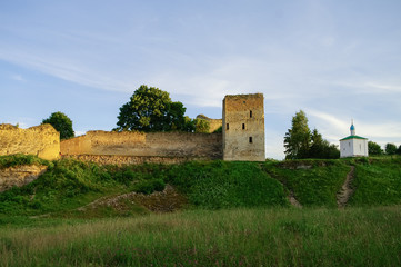 Fototapeta na wymiar A view of the medieval Izborsk fortress walls and towers in sunset, Pskov region,Russia