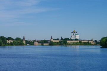 Fototapeta na wymiar Panorama view from Volhov river of Trinity Cathedral, the bell tower and the walls and tower of Pskov Kremlin. Pskov, Russia