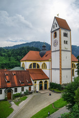 Fototapeta premium Clock tower of Hohes schloss, medieval castle in the middle of Fussen old town, Bavarian Alps, Germany