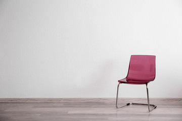 Pink chair in light room interior