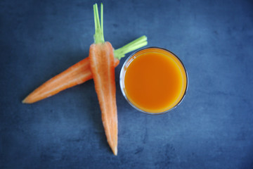 Fresh carrot juice in glass on table