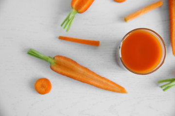 Fototapeta na wymiar Fresh carrot juice on wooden table