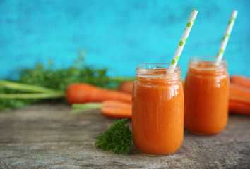 Fresh carrot juice on color background