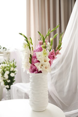Beautiful decorated interior with bouquet of flowers in vase
