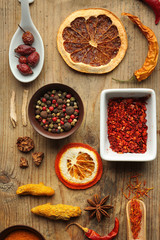 Flat lay of assorted herbs and spices on wooden background
