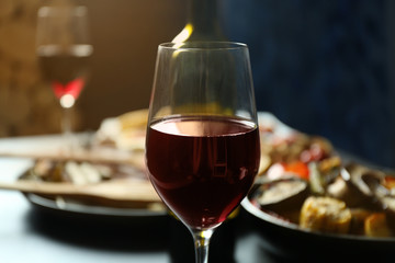 Glass of wine and grilled vegetables on served table