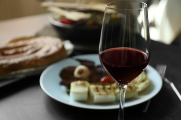 Glass of wine and grilled vegetables on served table
