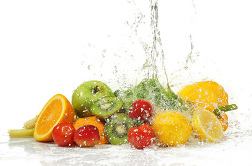 Fototapeta na wymiar Vegetables and fruits with splashing water on white background