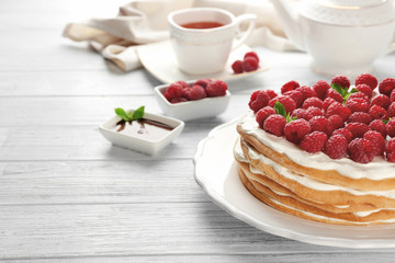 Tasty raspberry cake on wooden background