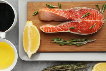 Salmon with spices on cutting board