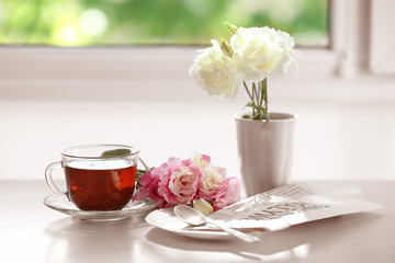 Cup of tea with flowers on table