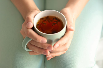 Woman holding cup of tea