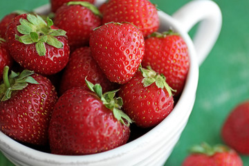 Fresh strawberries in cup, closeup
