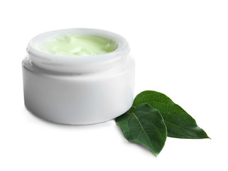 Facial cream and green leaves on white background