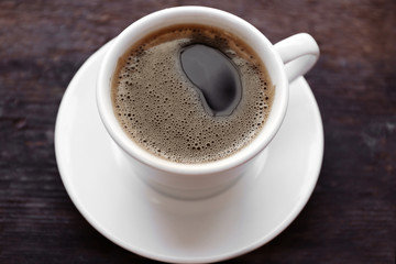 Cup of coffee on wooden background